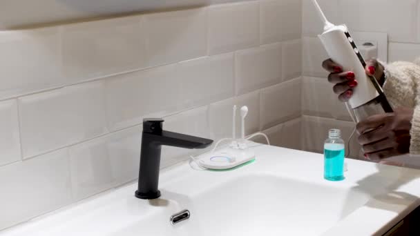 Effortless Oral Health Woman Filling Water Flosser Tank Bathroom Basin — Wideo stockowe