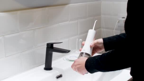 Effortless Oral Health Woman Filling Water Flosser Tank Bathroom Basin — Stockvideo