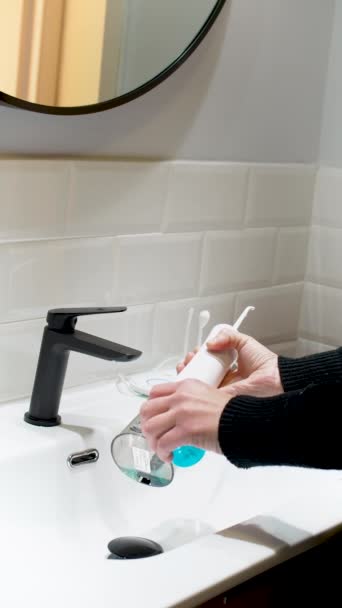 Effortless Oral Health Woman Filling Water Flosser Tank Bathroom Basin — Video Stock