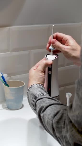 Young Man Hands Changing His Domestic Dental Water Flosser Tip — Vídeos de Stock