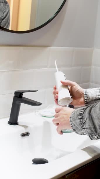 Effortless Oral Health Man Filling Water Flosser Tank Mouthwash Bathroom — Wideo stockowe