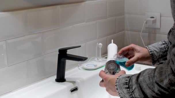 Effortless Oral Health Man Filling Water Flosser Tank Mouthwash Bathroom — Wideo stockowe