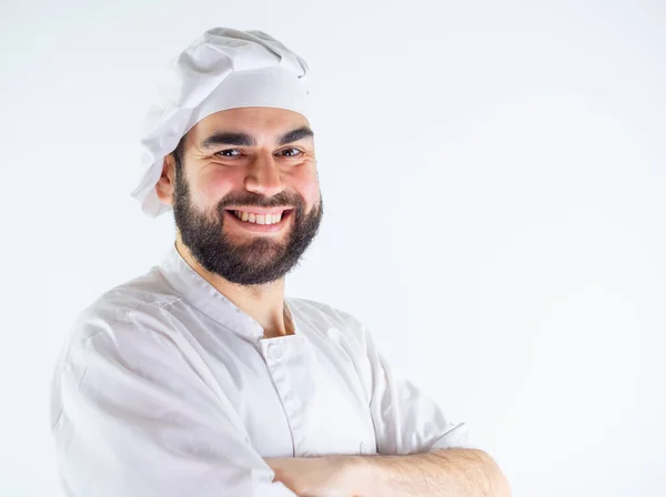 stock image Young male chef portrait with arms crossed while smiling and looking at camera. Isolated on a white background