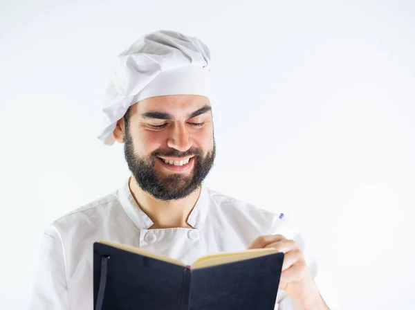 Young Male Chef Using Notebook Writing Recipe Isolated White Background — Stock Photo, Image