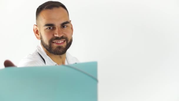 Young Male Doctor Taking Folder Checking Information While Smiling Isolated — Stock Video