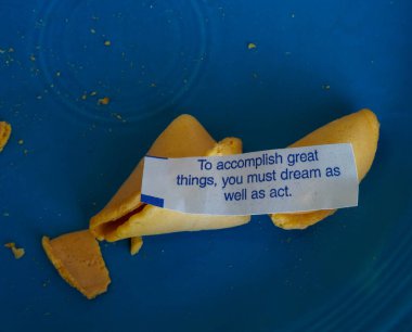 Fortune cookie positing that dreams happen when you act.