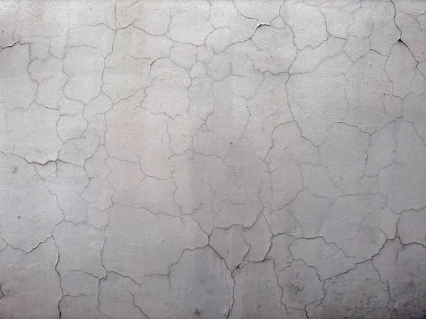 old cracked wall background texture for copy space. textured white plaster cracks for graphic design