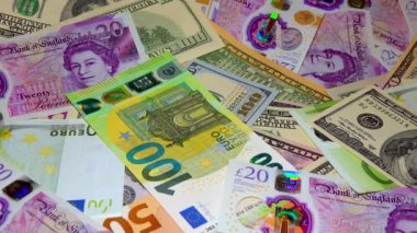 Banknotes English pound, dollar, euro, close-up, on a dark and white background