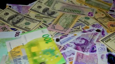 Banknotes English pound, dollar, euro, close-up, on a dark and white background