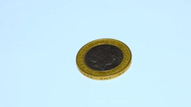 British pound coins put on a table on a white background