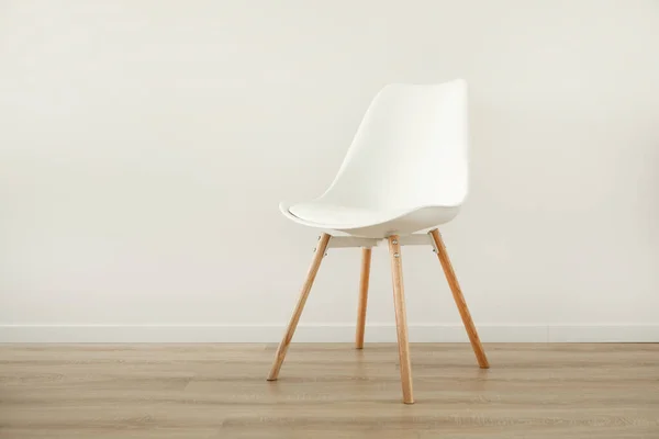 White chair in a white room for copy space. The concept of minimalism. High quality photo
