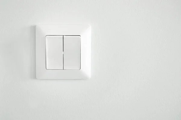Light switch on white wall. High quality photo