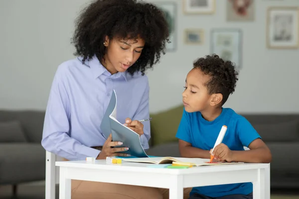 Young Teacher Helps Boy Elementary School Lessons Shows Lesson Book — Stock Photo, Image