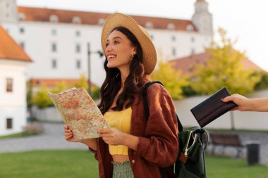 Kadın turist çantasından cüzdan çalan yankesici hırsızı. Bu arada elinde harita tutan ve hayran olunan tarihi binalara bakan kadın.