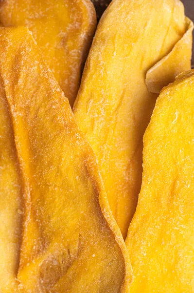 Slices of large sweet dried mangoes. Close up macro. Top view.