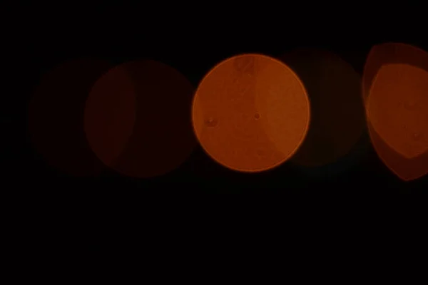 Abstract backgrounds. blur bokeh. Blurry orange light from the lamp which has a perfect round shape