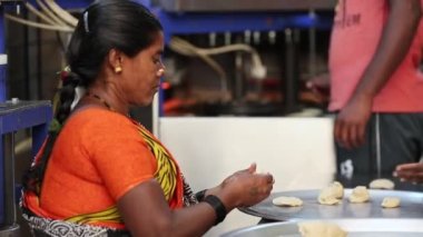 Kaiwara,Chikkaballapura,India-January 5,2017:Closeup of Indian lady preparing dough to make chapati or flatbread with bare hands