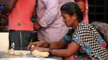 Kaiwara,Chikkaballapura,India-January 5,2017:Closeup of Indian lady preparing dough to make chapati or flatbread with bare hands