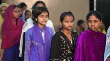 Kaiwara,Chikkaballapura,India-January 5,2017:Female students wait in line in the school canteen for meals at dinner time