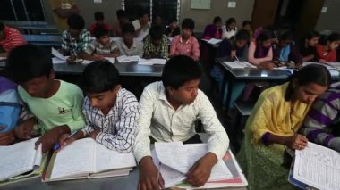 Kaiwara,Chikkaballapura,India-January 5,2017:Inside the classroom kids both males and girls can be seen reading during evening time