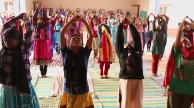 Kaiwara,Chikkaballapura,India-January 5,2017:A group of female students practicing Yoga at school open auditorium during mornings