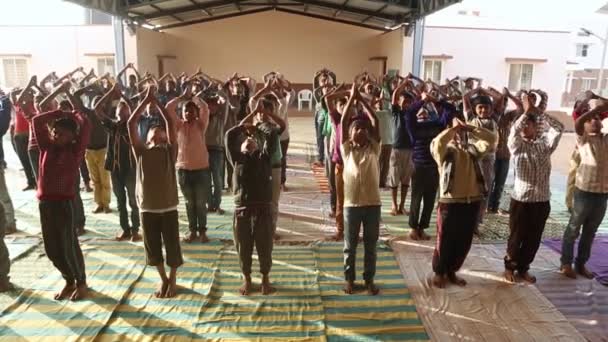 2017年1月5日インド チッカブラプラプラ州カイワラ 午前中に学校の野外講堂でヨガを実践する男性学生グループ — ストック動画