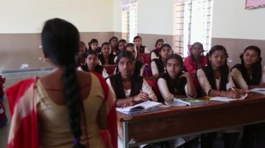 Kaiwara,Chikkaballapura,India-January 5,2017:Wide view of children sitting on the benches while teacher is teaching in classroom in rural school of karnataka