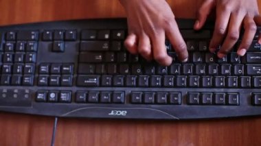 Kaiwara,Chikkaballapura,India-January 5,2017:A closeup of a childs fingers typing on a black keyboard during computer classes