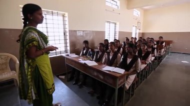Kaiwara,Chikkaballapura,India-January 5,2017:Wide view of children sitting on the benches while teacher is teaching in classroom in rural school of karnataka