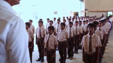 Kaiwara,Chikkaballapura,India-January 6,2017:Students singing the national anthem at morning assembly in uniform at rural school in karnataka
