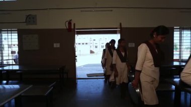Kaiwara,Chikkaballapura,India-January 6,2017:A video of female students entering the dining hall to have meal at lunch time at rural school in karnataka