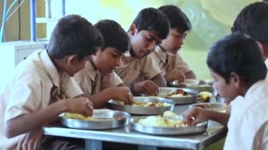 Kaiwara,Chikkaballapura,India-January 6,2017:Close up of male students eating food together in the school canteen at lunch time