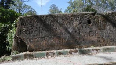 Closeup of names written by visitors on the walls of nandi hills fort during summer