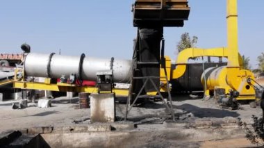 A wide view of the asphalt production factory with machines at rural village of india