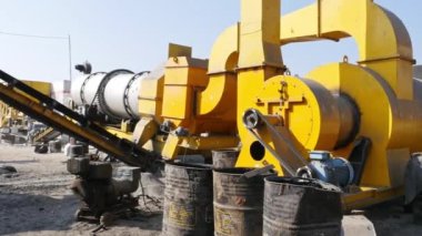 A wide view of the asphalt production factory with machines at rural village of india