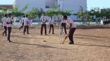 Kaiwara,Chikkaballapura,India-January 5,2017:A closeup of a boy batting while playing cricket on the playground during play time at the school campus