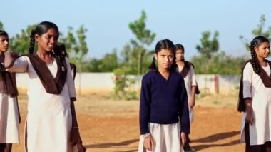 Kaiwara,Chikkaballapura,India-January 5,2017:A closeup of female students playing volleyball on the playground during the evening