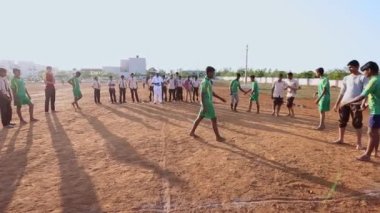 Kaiwara,Chikkaballapura,India-January 5,2017:Wide view of male students playing kabaddi on the playground during the evening