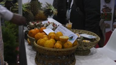 Bangalore,India-January 22,2023:A close-up of organic kachai lemons in a basket displayed at an international trade show