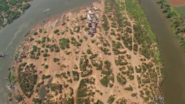 Aerial view of a crowd of people camping and bathing around the large riverbank during the Hindu religious festival karnikotsava(prophecy),mailaralingeshwara karnika