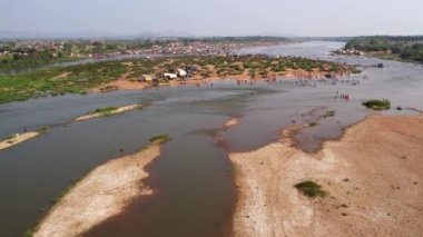 An aerial view of a huge crowd of people camped on the riverbank during a Hindu religious festival karnikotsava(prophecy),mailaralingeshwara karnika