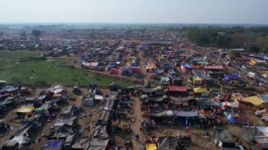 Vijayanagara,India-February 7,2023:An aerial shot of a crowded county fair with colourful tents, shops, and devotees sheltered on the fields during a Hindu religious festival karnikotsava(prophecy)