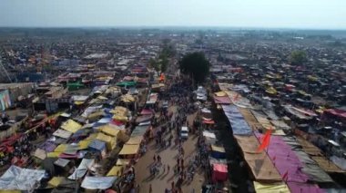 Vijayanagara,India-February 7,2023:Aerial track view of a huge crowd moving on busy roads amidst a crowded fair during a Hindu religious festival karnikotsava(prophecy)