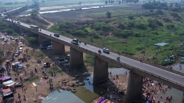Aerial View Vehicles Crossing River Bridge People Bathing Large River — Video