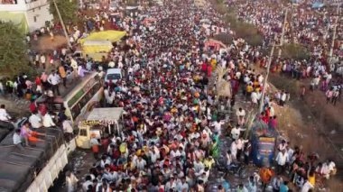 Vijayanagara,India-February 7,2023:Aerial view of crowd of people moving on the busy roads during annual hindu religious event karnikotsava or prophecy