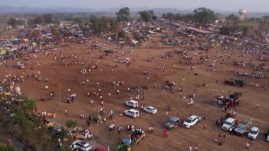 Vijayanagara,India-February 7,2023:Aerial view of farmland with crowds and camping during the hindu religious event karnikotsava or prophecy