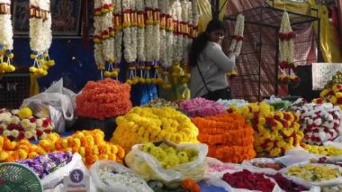 Bangalore,India-February 12,2023:A view of florist selling a large selection of flowers and garlands in a flower shop on the roadside