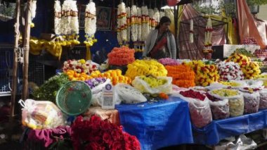 Bangalore,India-February 12,2023:A view of florist selling a large selection of flowers and garlands in a flower shop on the roadside