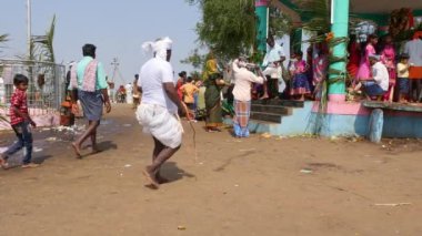 Vijayanagara,India-February 5,2023:An old man punishes himself with a whip for his sins at the temple during the hindu religious festival