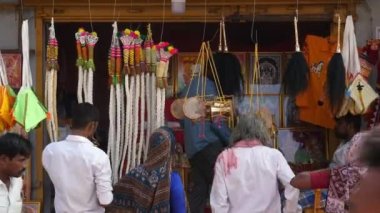 Vijayanagara,India-February 5,2023:A closeup of whips and power drums or damru for sale at shop during religious festival